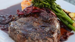 Keto meal ingredients beside carnivore meal ingredients on a neutral table without labels