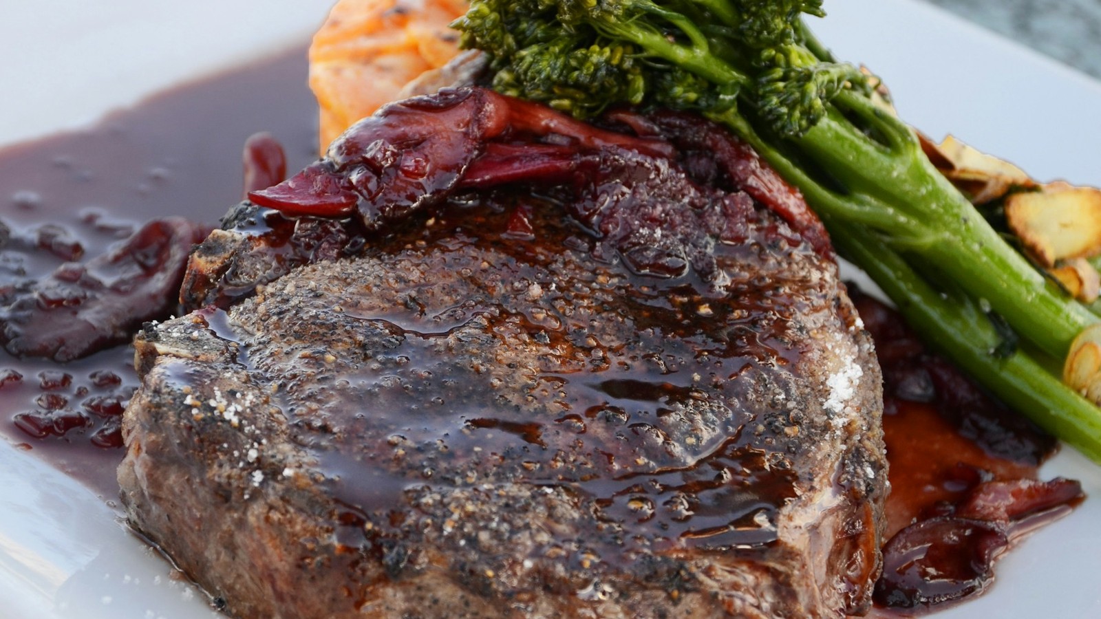 Keto meal ingredients beside carnivore meal ingredients on a neutral table without labels